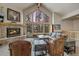 Comfortable living room featuring a stone fireplace, large windows, and cozy seating arrangement perfect for relaxation at 89 Fairview Cir, Breckenridge, CO 80424