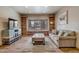 Comfortable living room featuring built-in bookshelves and large windows overlooking a snowy landscape at 89 Fairview Cir, Breckenridge, CO 80424