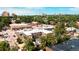 Aerial view of a neighborhood showing storefronts, residential buildings, and lush trees at 558 N Washington St # 103, Denver, CO 80203