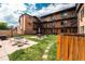 Complex backyard featuring communal outdoor space with picnic tables, lounge chairs, and lush greenery at 558 N Washington St # 103, Denver, CO 80203