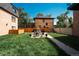Backyard featuring a well-maintained lawn, patio furniture, and a surrounding fence for privacy at 558 N Washington St # 103, Denver, CO 80203