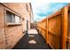 Private fenced yard with mulch, stone pavers, and a small patio area offering a serene outdoor space next to a brick building at 558 N Washington St # 103, Denver, CO 80203