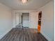 Cozy bedroom with wood floors and a mirrored closet adjacent to the bathroom at 558 N Washington St # 103, Denver, CO 80203