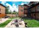 Apartment courtyard featuring exterior stairways, outdoor seating, and beautiful landscaping at 558 N Washington St # 103, Denver, CO 80203