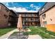The apartments feature a beautiful courtyard with black iron stairways and outdoor seating at 558 N Washington St # 103, Denver, CO 80203