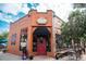 Exterior view of Pablos Coffee shop showcasing a red awning and brick design at 558 N Washington St # 103, Denver, CO 80203