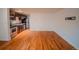 Living room with hardwood floors, a kitchen with stainless steel appliances, and white walls to create a modern living space at 558 N Washington St # 103, Denver, CO 80203