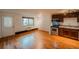 Combined living room and kitchen area with hardwood floors, stainless steel appliances, and a window offering natural light at 558 N Washington St # 103, Denver, CO 80203