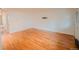 Bright living room features hardwood floors, white walls, and a wall-mounted TV bracket for easy entertainment setup at 558 N Washington St # 103, Denver, CO 80203