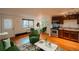 A well-decorated living area with hardwood floors, a kitchen in the background, and a dining table for comfortable living at 558 N Washington St # 103, Denver, CO 80203