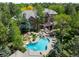 Stunning home aerial view featuring a pristine pool and lush landscaping nestled among mature trees at 5851 S Colorado Blvd, Greenwood Village, CO 80121