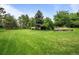 Large, level backyard space with lush green grass and wooded perimeter at 5851 S Colorado Blvd, Greenwood Village, CO 80121