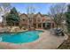 Resort-style backyard with pool, patio, outdoor dining, and lush landscaping at 5851 S Colorado Blvd, Greenwood Village, CO 80121