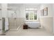 Modern bathroom with a freestanding tub, glass shower, and large window at 5851 S Colorado Blvd, Greenwood Village, CO 80121