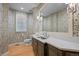 Well-lit bathroom features hardwood floors, a large mirror and floral wallpaper at 5851 S Colorado Blvd, Greenwood Village, CO 80121