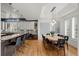 Open-concept dining area featuring hardwood floors, modern lighting, and large windows at 5851 S Colorado Blvd, Greenwood Village, CO 80121