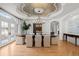 Elegant dining room featuring hardwood floors, french doors, and a decorative tray ceiling with a chandelier at 5851 S Colorado Blvd, Greenwood Village, CO 80121