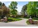 Inviting driveway entrance flanked by brick pillars and lush landscaping leading to the home at 5851 S Colorado Blvd, Greenwood Village, CO 80121