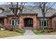 Charming brick home entrance with arched doorway and well-maintained landscaping at 5851 S Colorado Blvd, Greenwood Village, CO 80121