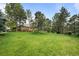 Expansive lawn with mature trees surrounding the brick home at 5851 S Colorado Blvd, Greenwood Village, CO 80121
