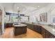 Open kitchen with large island, granite countertops, custom cabinetry and stainless steel range hood at 5851 S Colorado Blvd, Greenwood Village, CO 80121