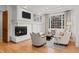Cozy living room with a fireplace, built-in shelving, and comfortable seating at 5851 S Colorado Blvd, Greenwood Village, CO 80121