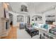 Bright living room features a fireplace, a vaulted ceiling with chandelier, and large windows for ample natural light at 5851 S Colorado Blvd, Greenwood Village, CO 80121