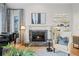 Comfortable living room showcasing a stone fireplace, piano, and ample natural light at 5851 S Colorado Blvd, Greenwood Village, CO 80121