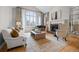 Bright living room with a fireplace, piano, and large windows offering a view at 5851 S Colorado Blvd, Greenwood Village, CO 80121