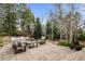 Expansive stone patio with comfortable seating in a lush, wooded backyard at 5851 S Colorado Blvd, Greenwood Village, CO 80121