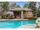 Stylish pool house with an outdoor kitchen and seating area, perfect for poolside gatherings at 5851 S Colorado Blvd, Greenwood Village, CO 80121