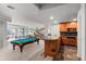 Spacious basement with bar, stairs, billiard table, and seating area at 5851 S Colorado Blvd, Greenwood Village, CO 80121