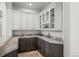 Elegant wet bar featuring granite countertops, custom cabinets, and stylish tile flooring at 5851 S Colorado Blvd, Greenwood Village, CO 80121