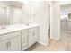 Bathroom with wood-look floor features a double vanity, large mirror, and walk-in closet at 24008 E Atlantic Pl, Aurora, CO 80018