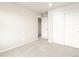 This bedroom has neutral-colored walls and carpeting with a closet at 24008 E Atlantic Pl, Aurora, CO 80018