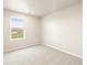 This bedroom has a window and neutral-colored carpet at 24008 E Atlantic Pl, Aurora, CO 80018