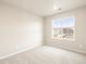 This bedroom has neutral-colored walls and carpeting and a window at 24008 E Atlantic Pl, Aurora, CO 80018