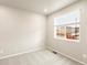 Clean bedroom features neutral carpet, white walls, and a large window for natural light at 24008 E Atlantic Pl, Aurora, CO 80018