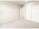 Neutral bedroom with an open door and closet with white sliding doors at 24008 E Atlantic Pl, Aurora, CO 80018