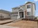 Lovely two-story home with stone accents, gray siding, and a charming covered front porch at 24008 E Atlantic Pl, Aurora, CO 80018