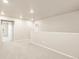 Hallway with neutral carpet leads to doorway and features neutral paint and recessed lighting at 24008 E Atlantic Pl, Aurora, CO 80018