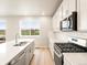 Kitchen featuring stainless steel appliances, quartz counters, and a view of the lawn at 24008 E Atlantic Pl, Aurora, CO 80018