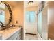 Bright bathroom with marble countertop vanity and shower/tub featuring clean lines and efficient layout at 7926 S Corona Ct, Centennial, CO 80122