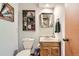 Half bathroom with rustic decor featuring decorative wall hangings, updated fixtures, and neutral colors at 7926 S Corona Ct, Centennial, CO 80122