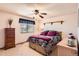 Cozy bedroom featuring a ceiling fan and bright window with wood furnishings, offering a comfortable retreat at 7926 S Corona Ct, Centennial, CO 80122