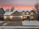 Two-story house with a three-car garage and snow-covered yard at 6460 W 98Th Ct, Westminster, CO 80021