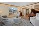 Living room with a grey sofa, coffee table, and a grand piano at 6460 W 98Th Ct, Westminster, CO 80021