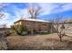 Spacious backyard with a brick house and mature trees, offering a blank canvas for outdoor enjoyment at 2683 E 90Th Pl, Thornton, CO 80229