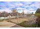 Large backyard space features a concrete patio, a white picket fence, and mature trees, creating a private outdoor area at 2683 E 90Th Pl, Thornton, CO 80229