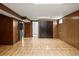 Spacious basement with wood paneled walls and hard wood floors at 2683 E 90Th Pl, Thornton, CO 80229